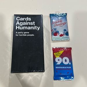 Cards Against Humanity and 2 packs brand new, sealed